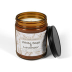 A 9oz amber glass jar candle with a black metal lid and a white paper label reading 'White Sage & Lavender' by Real Cool Company,