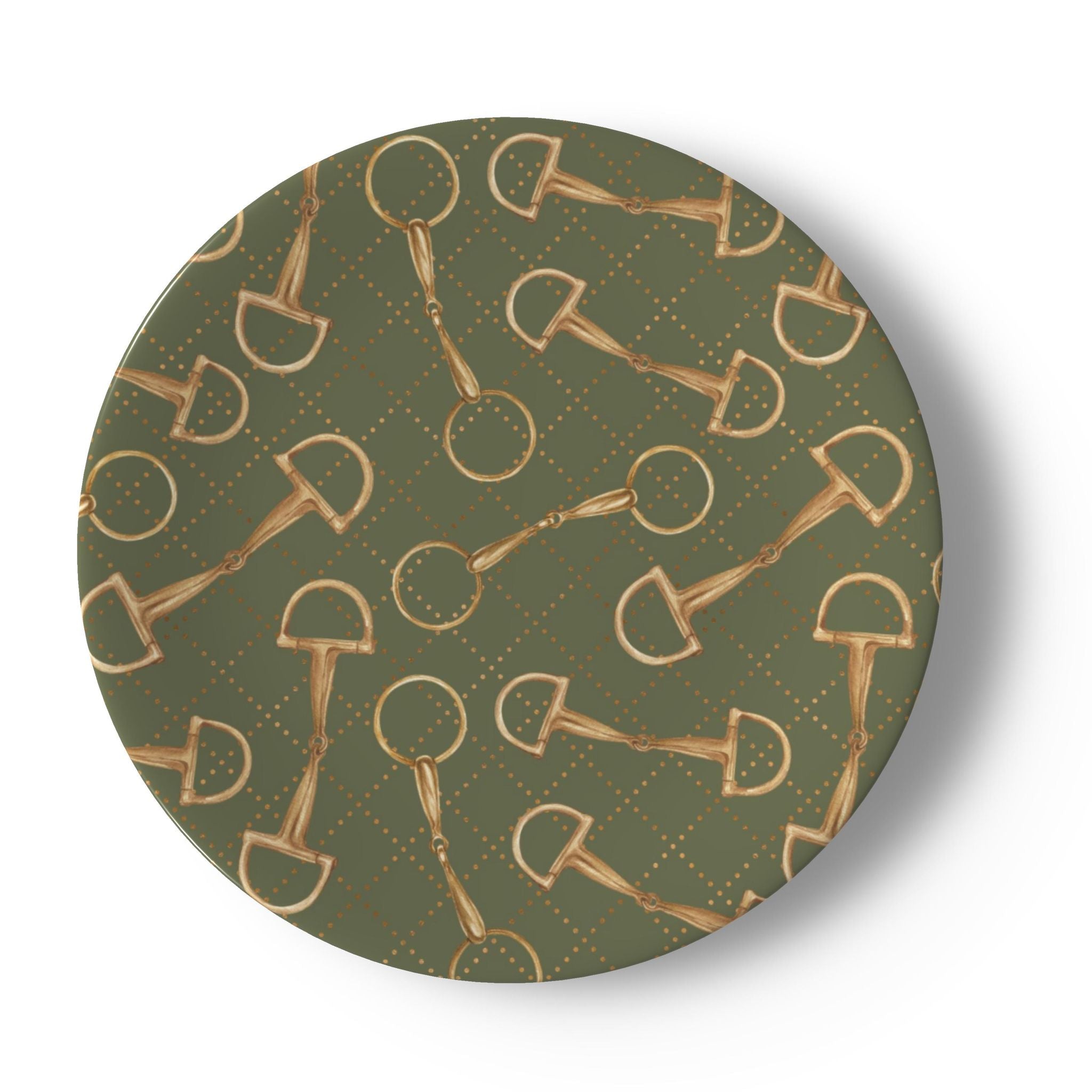 A round decorative plate featuring a repeating pattern of gold horse bits and rings over an olive green background with a subtle dotted diamond grid.