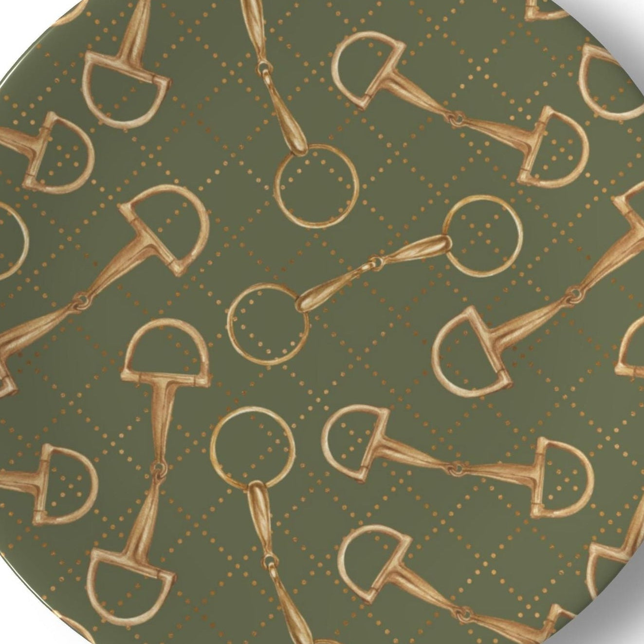 A round decorative plate featuring a repeating pattern of gold horsebit illustrations over an olive green background with a subtle diamond lattice design.