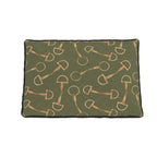 A rectangular pet bed with a dark olive green background featuring a repeating pattern of gold horse bits and small gold dotted lines, finished with a black stitched border.