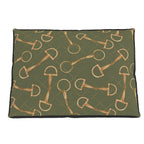 A rectangular pet bed with a dark olive green background featuring a repeating pattern of gold horse bits and dotted diamond shapes, finished with a black stitched border.
