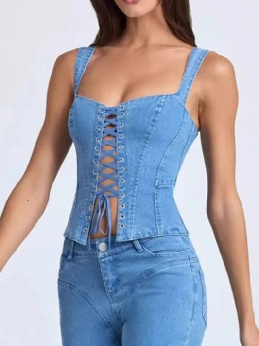 Blue denim corset top and pants on a model against a white background