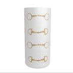 A tall frosted cylindrical shot glass decorated with a repeating pattern of gold horse bits, shown against a plain white background.