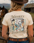 Cowgirl wearing Whiskey Cowboys and Bad Decisions western graphic tee on ranch
