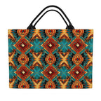 back side tote bag with a vibrant Southwestern geometric pattern in teal, orange, red, and black, featuring dual black shoulder straps, shown against a plain white background.
