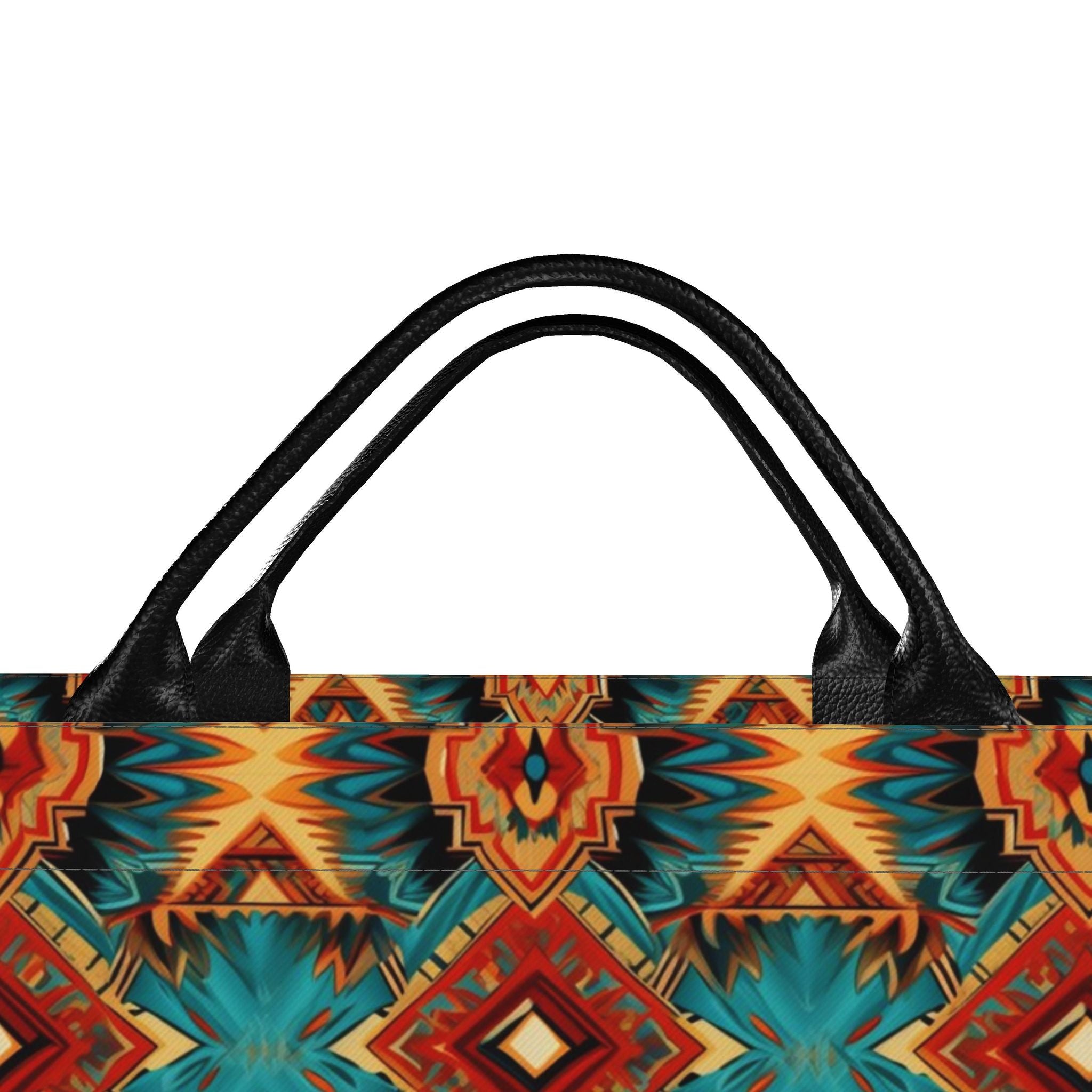 A close-up of a tote bag featuring a vibrant Southwestern geometric pattern in orange, red, teal, and yellow, with black textured handles on a plain white background.
